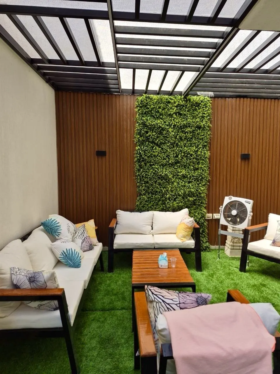 Full-height green wall along the courtyard lounge