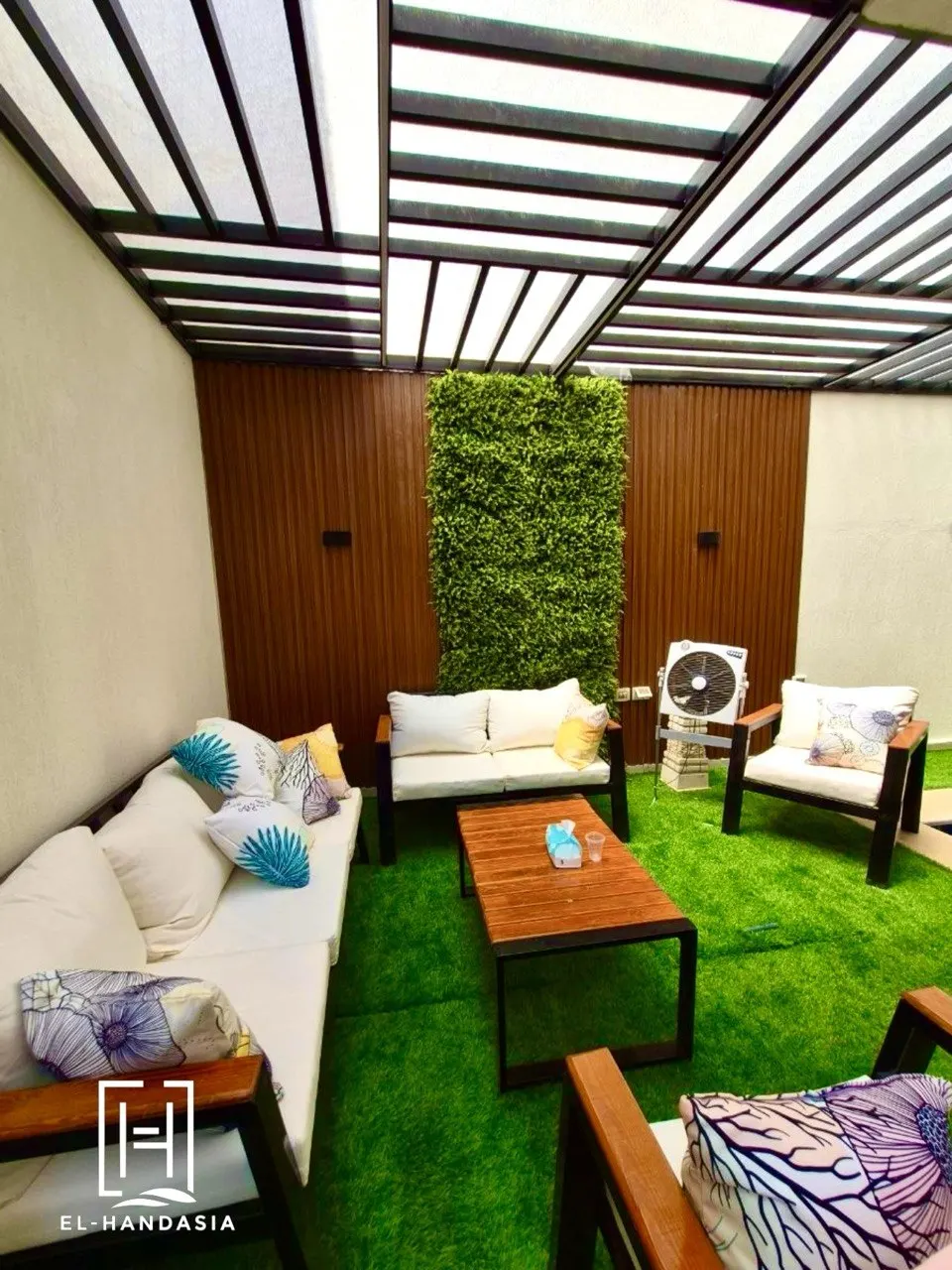 Courtyard seating area designed around a full-height green wall