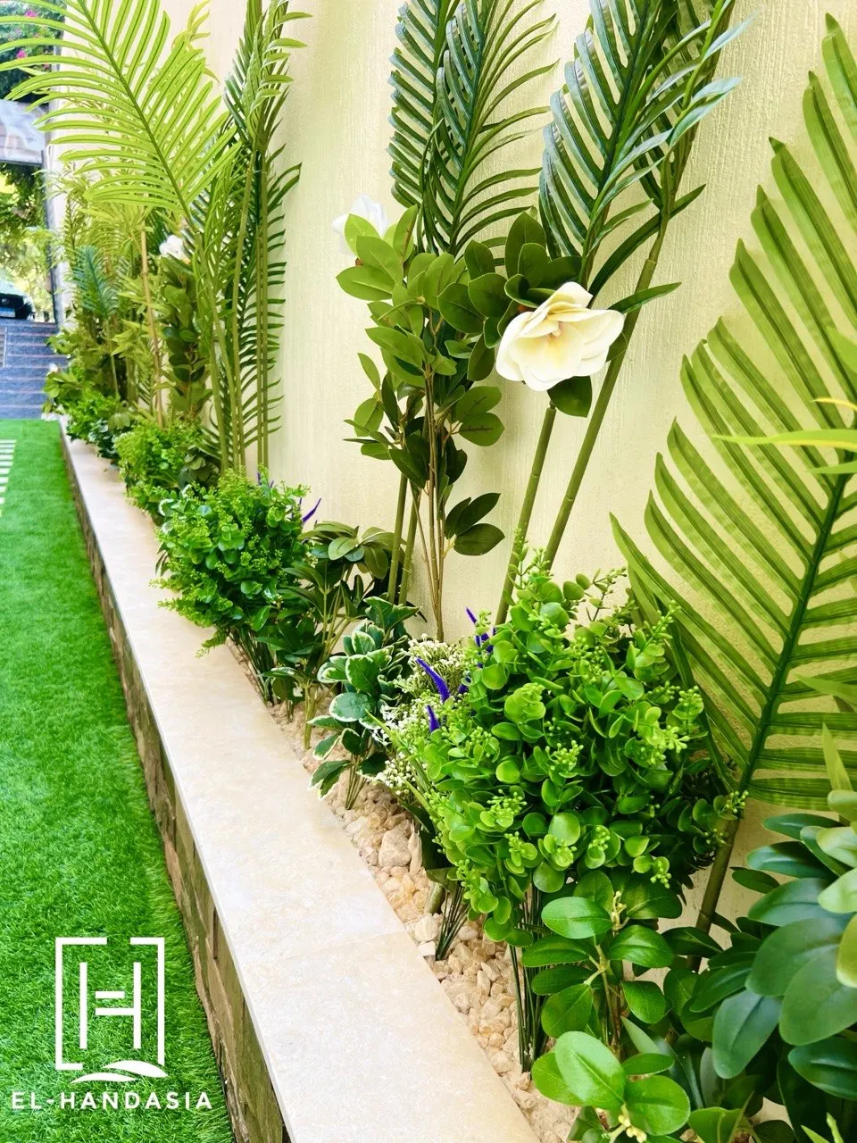 Stone paving and boundary wall cladding in a side garden